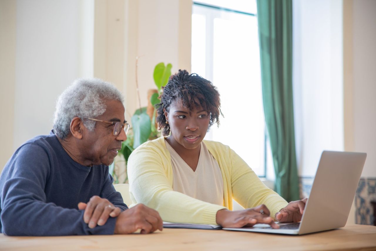 A technician explaining a laptop problem to a customer